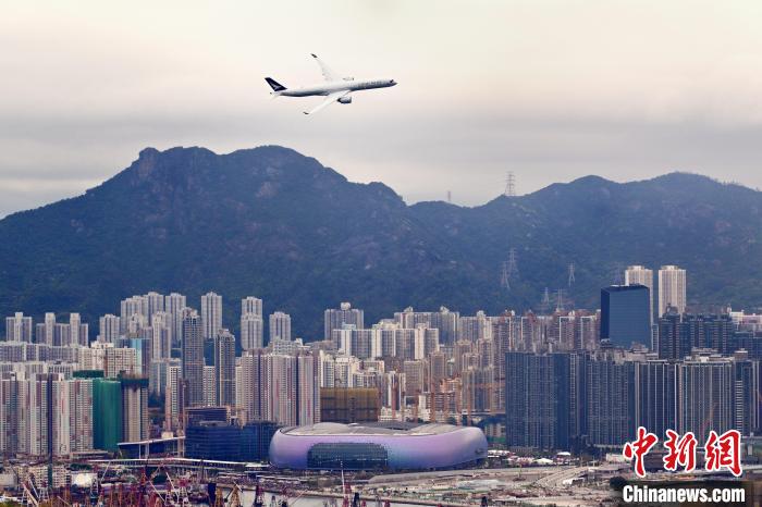 3月30日下午，国泰航空有限公司(简称“国泰航空”)安排一架客机低飞越过维多利亚港，掠过启德体育园附近上空，以纪念旧启德机场启用100周年。图为国泰航空客机在启德体育园上空飞过。