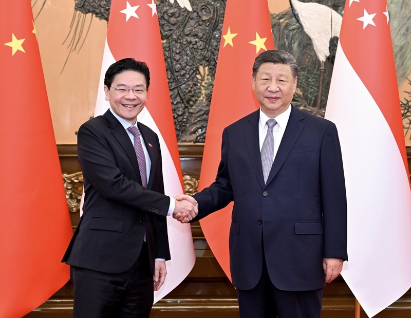 6月24日上午，国家主席习近平在北京人民大会堂会见来华进行正式访问的新加坡总理黄循财。图片来源：新华网